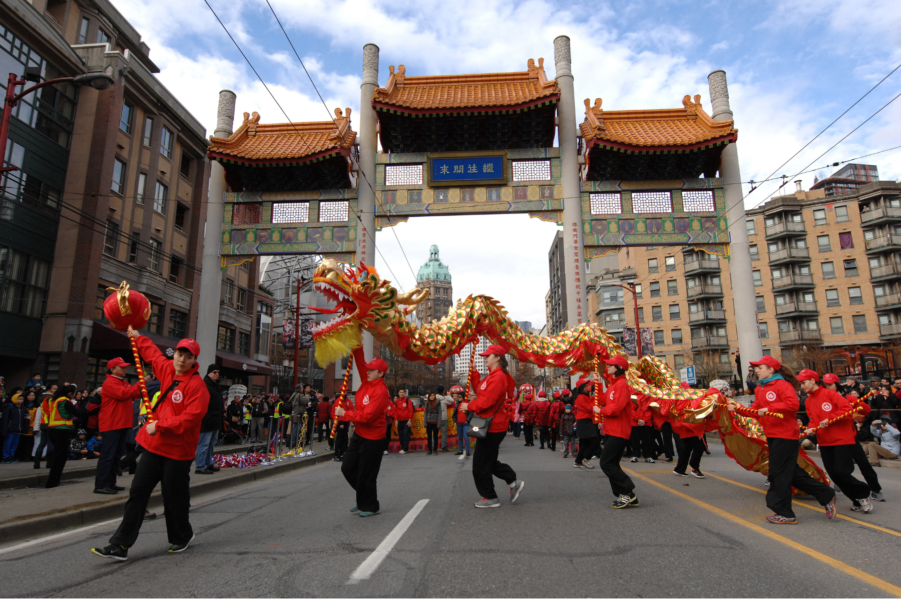 People operating a massive dragon in the Chinese New Year Parade and celebrations at Chinatown in Vancouver