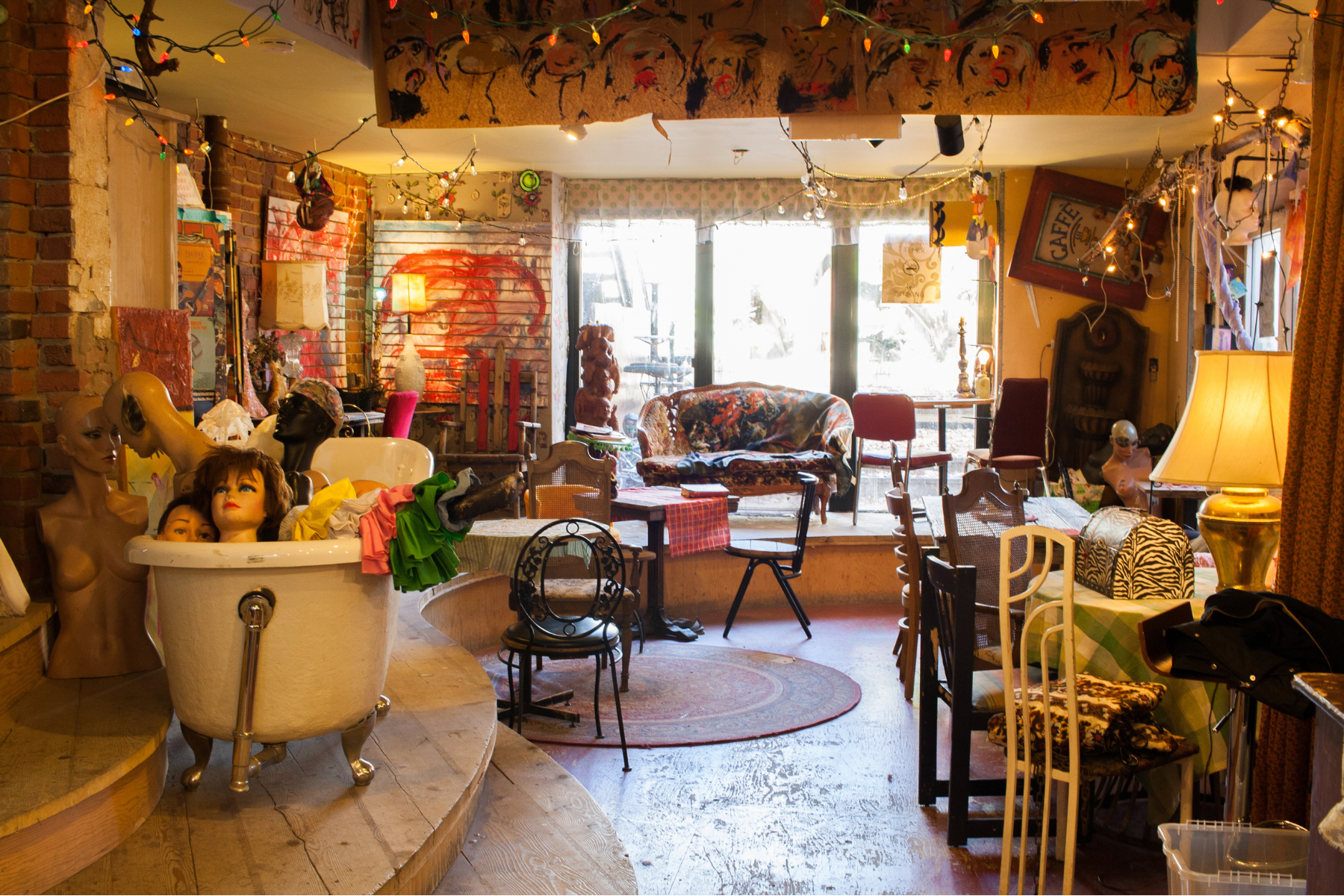 Interior of eccentric Eva B thrift store featuring manikin parts in a bath tub