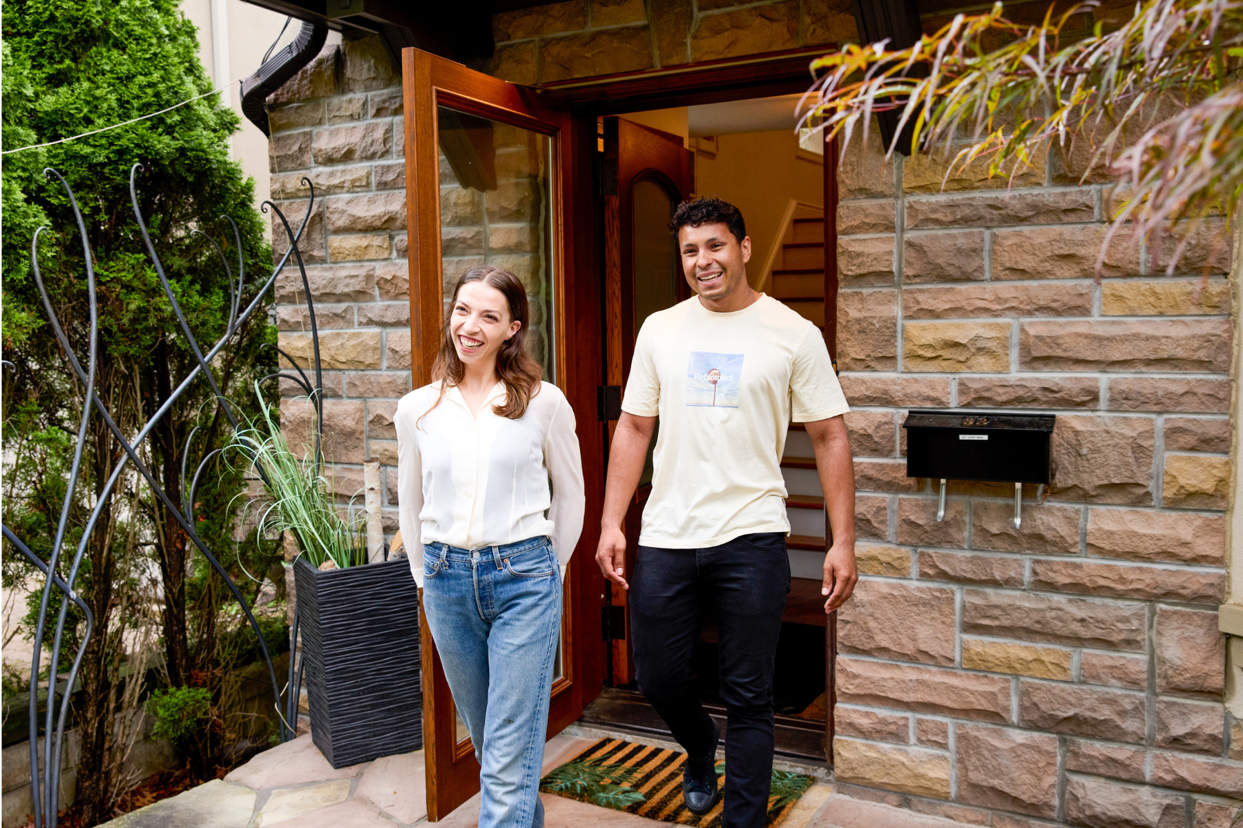 Canadian couple walking out of house in clothes for mild weather