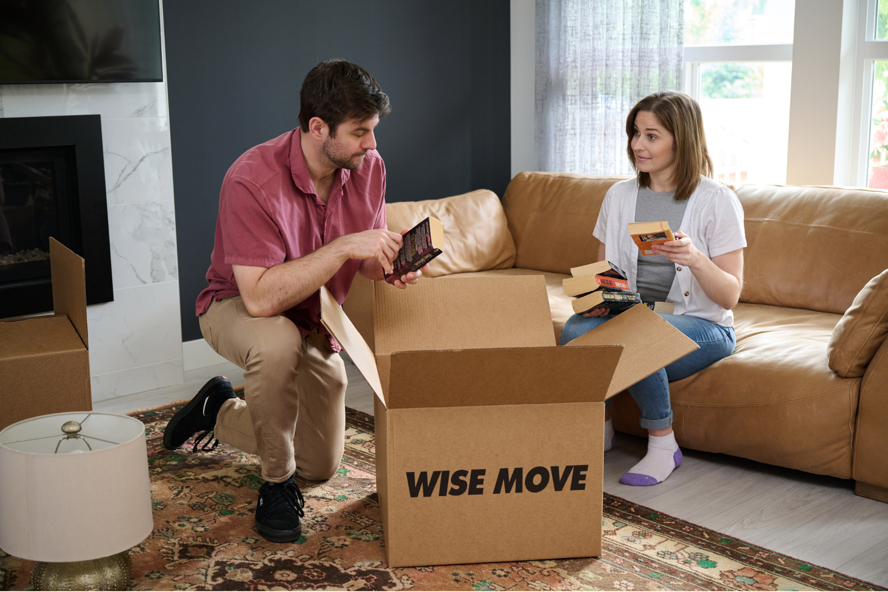 couple packing box with books