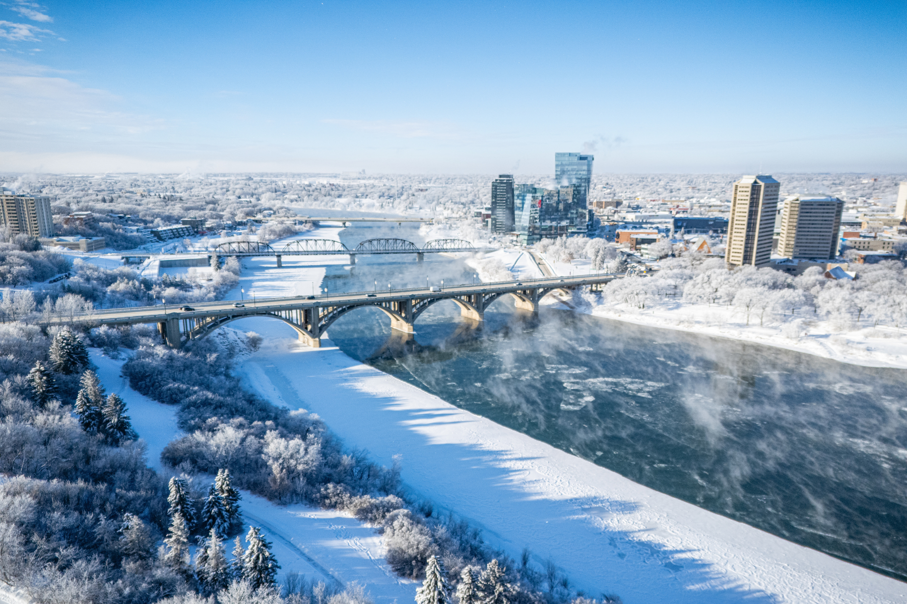 A snowy Saskatoon with a river running through 