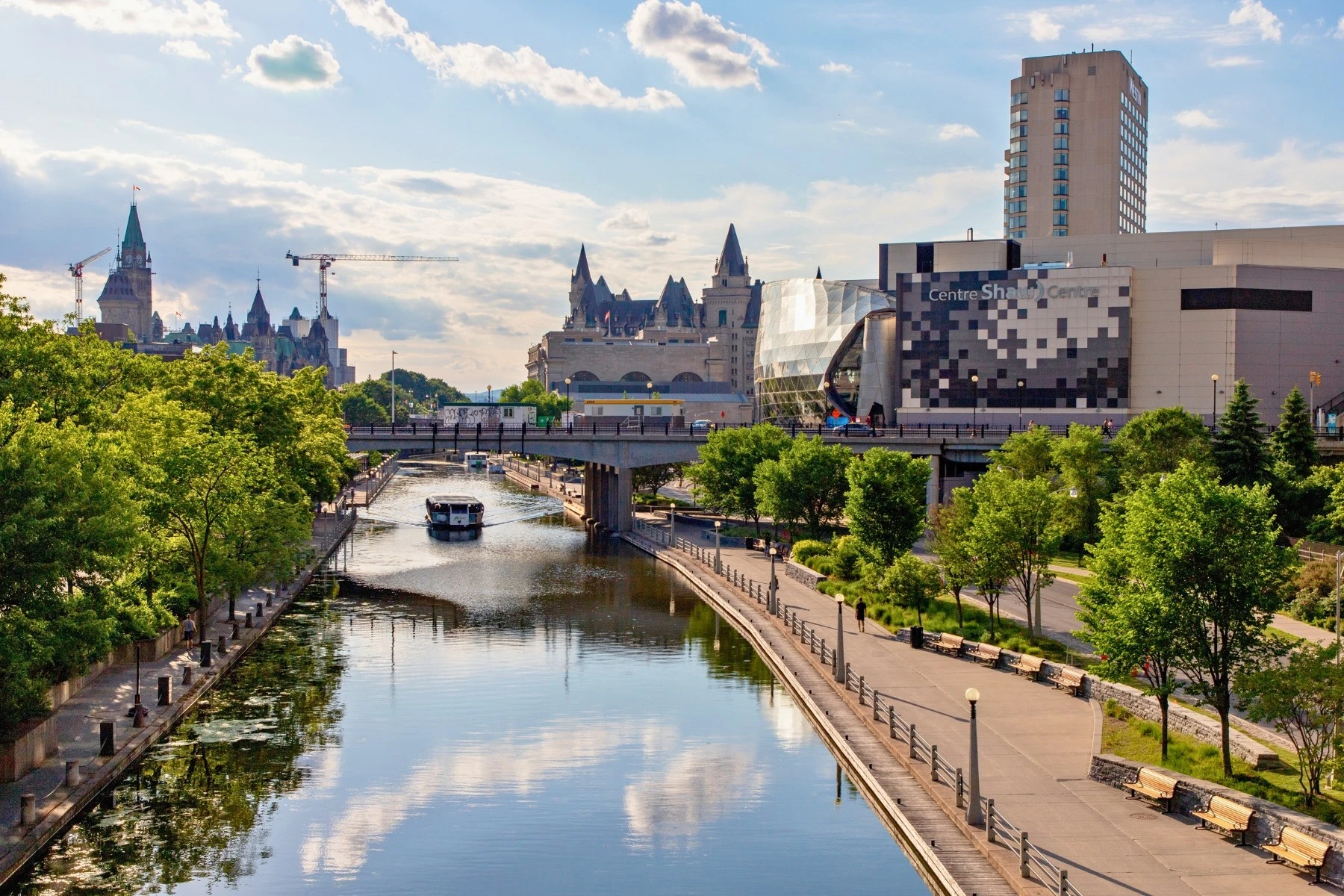 View of Rideau Canal with downtown Ottawa cityscape in the background
