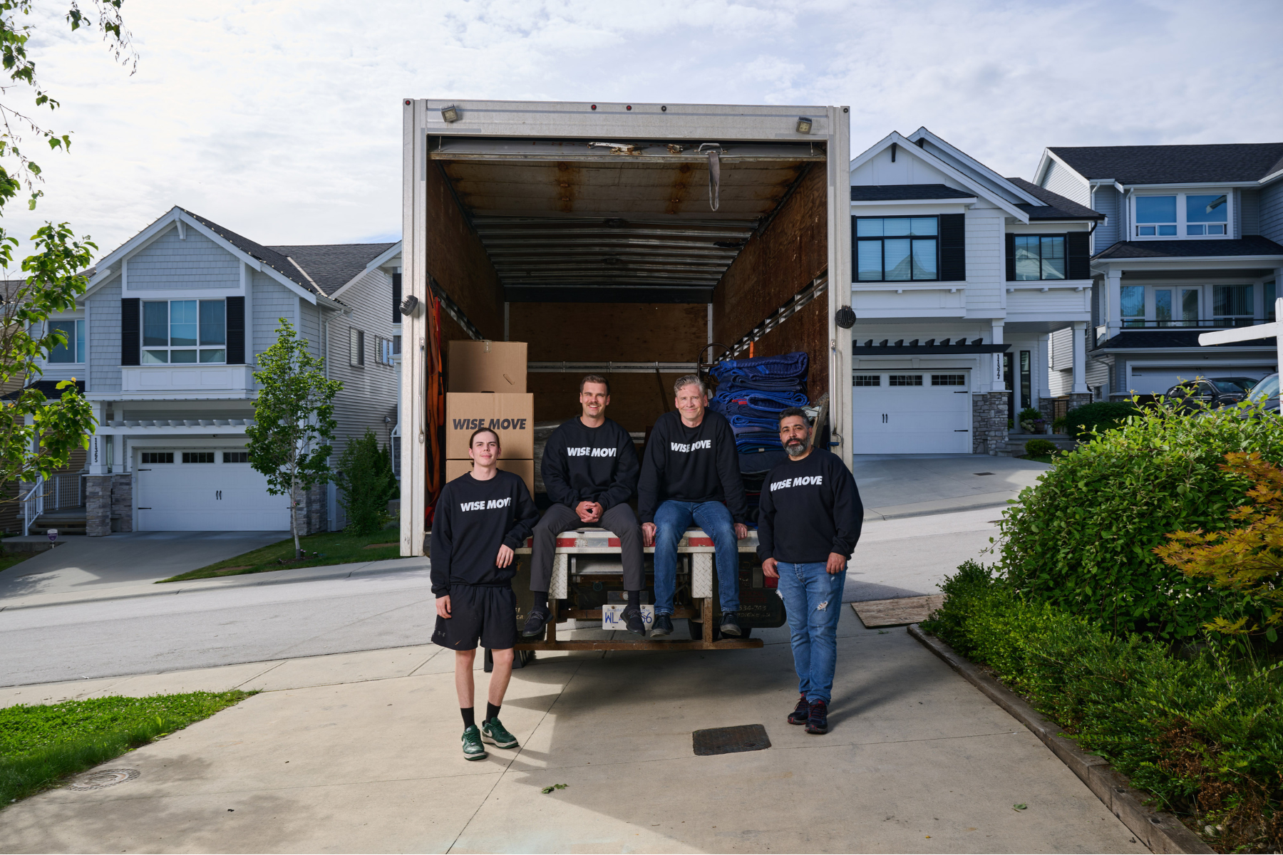 student-friendly moving team sitting in moving truck