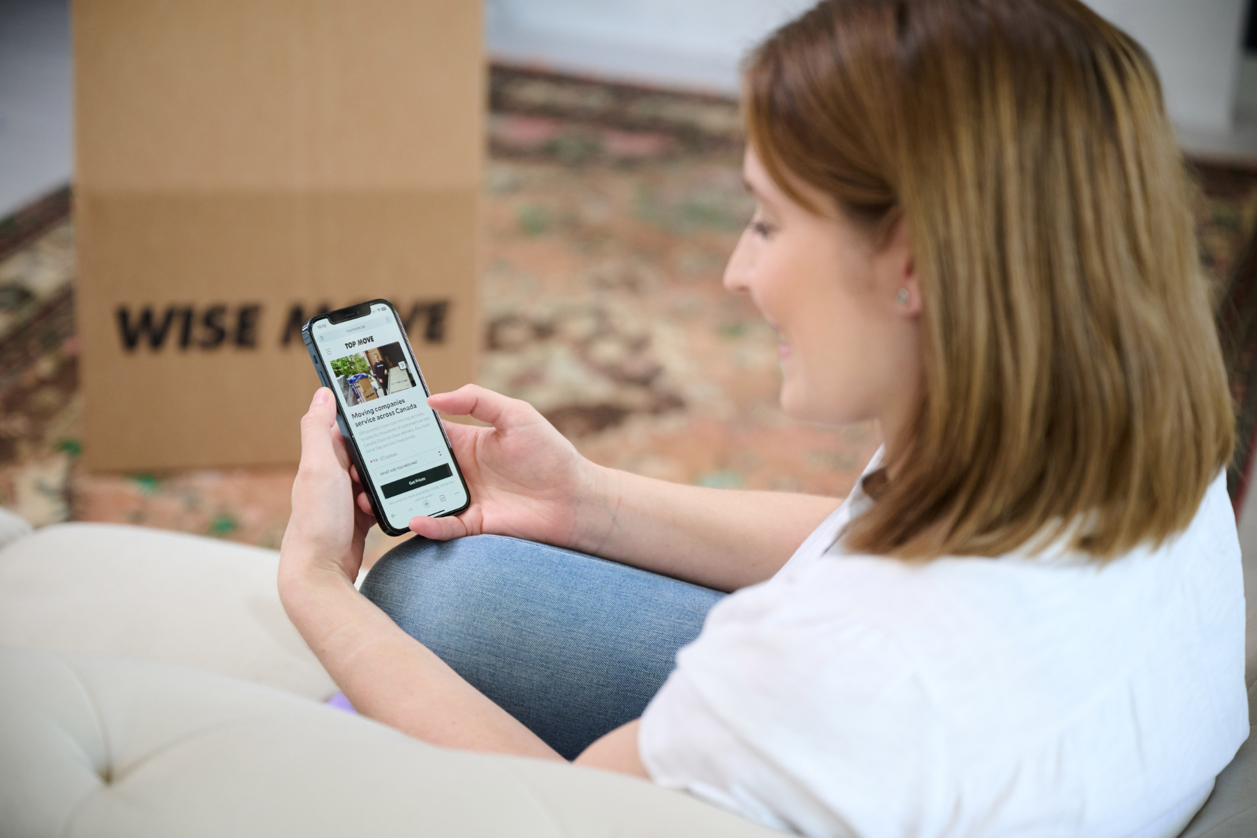 Student sitting on couch booking a moving company on Wise Move