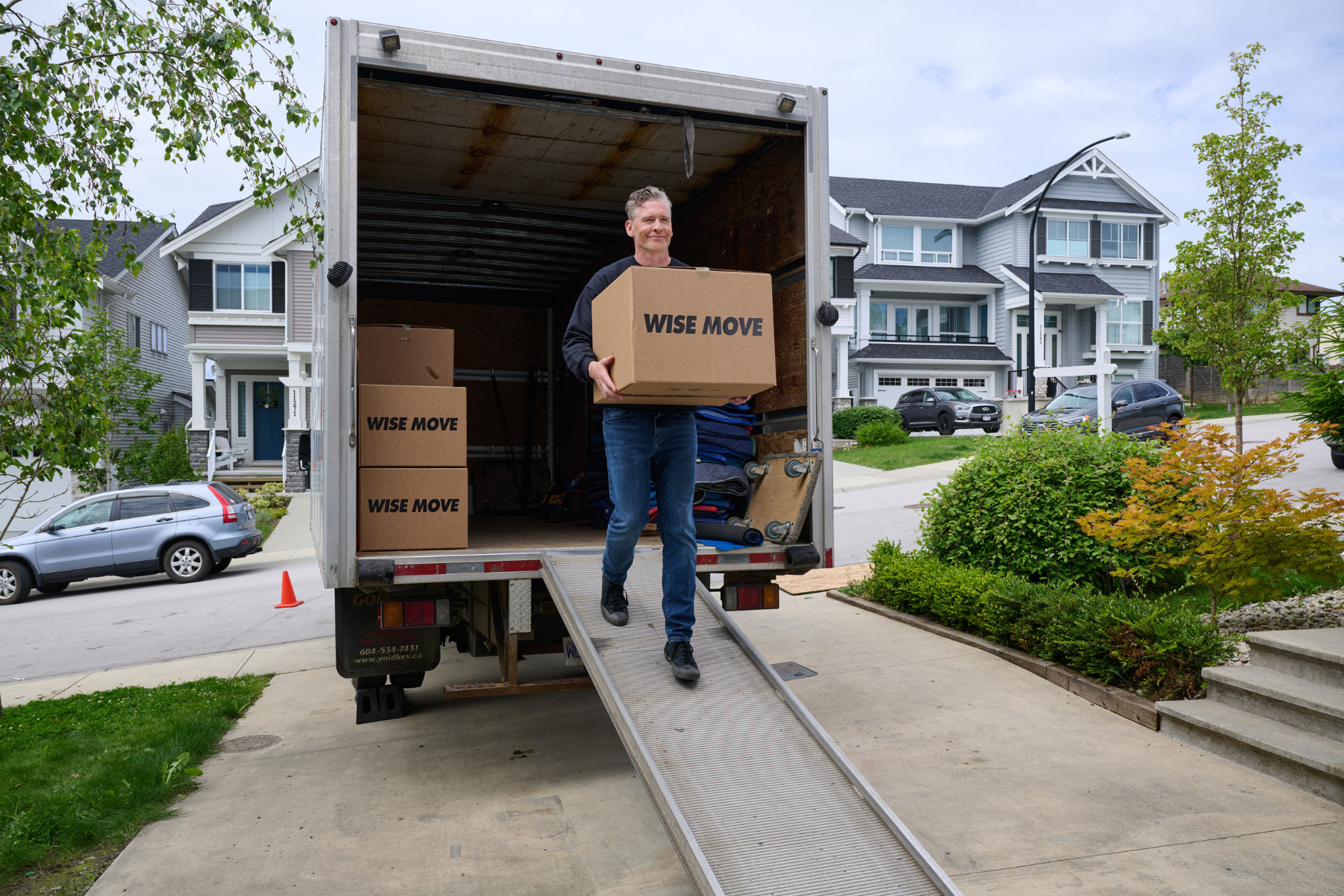 Wise Move moving service carrying boxes out of moving truck