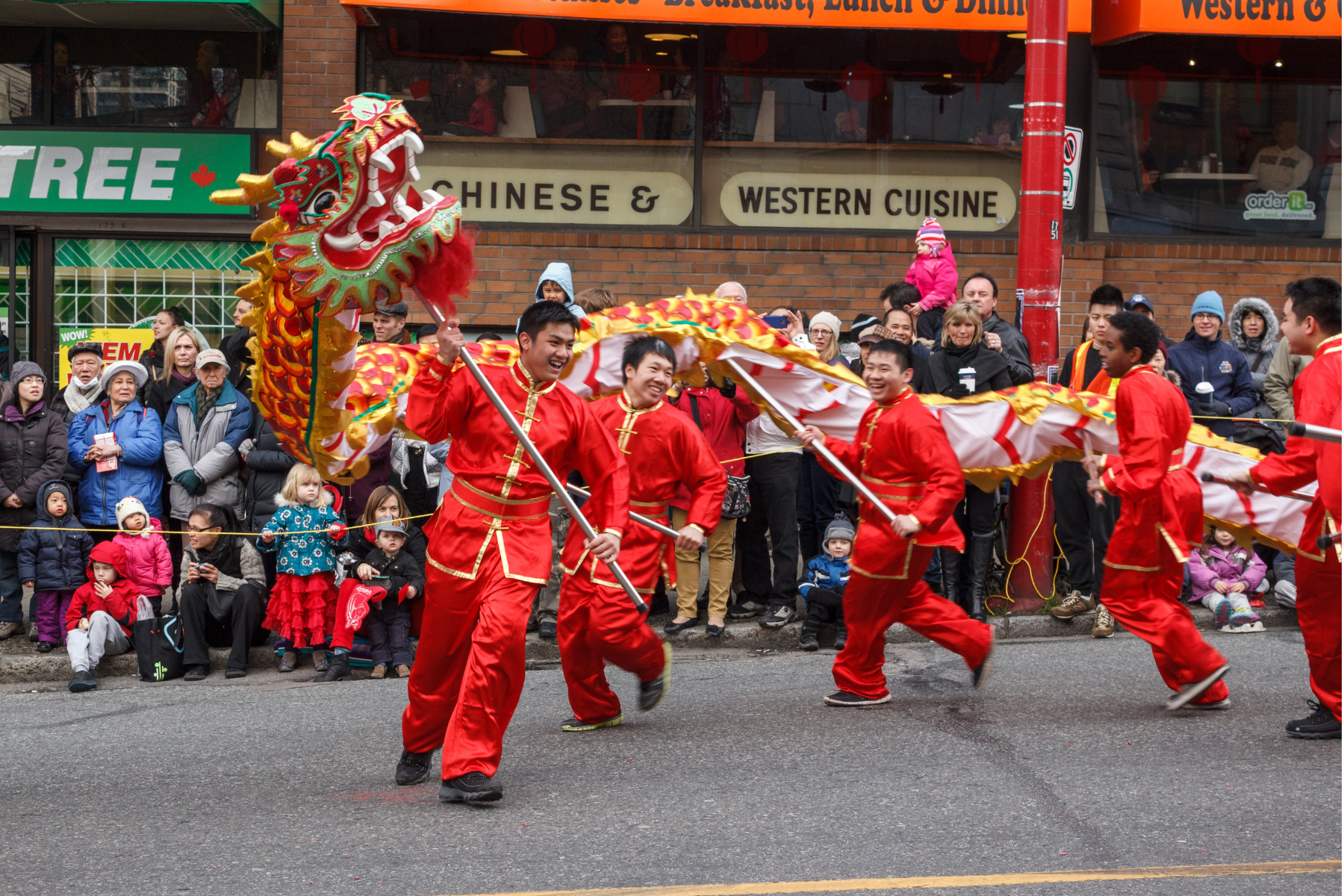 People operating a massive dragon in the Chinese New Year Parade and celebrations at Chinatown in Vancouver