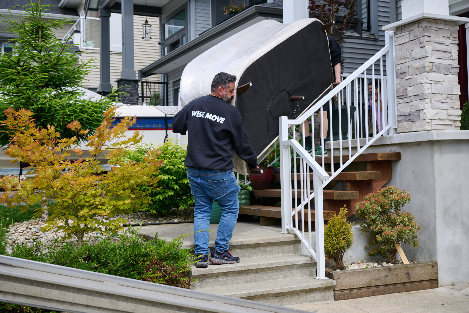 Movers moving a second-hand couch into a home in Ottawa