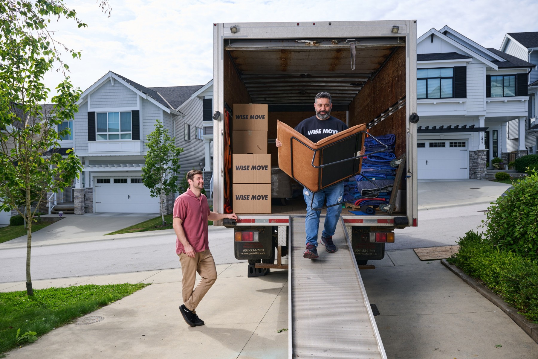Professional furniture moving team in Victoria unloading second-hand chair
