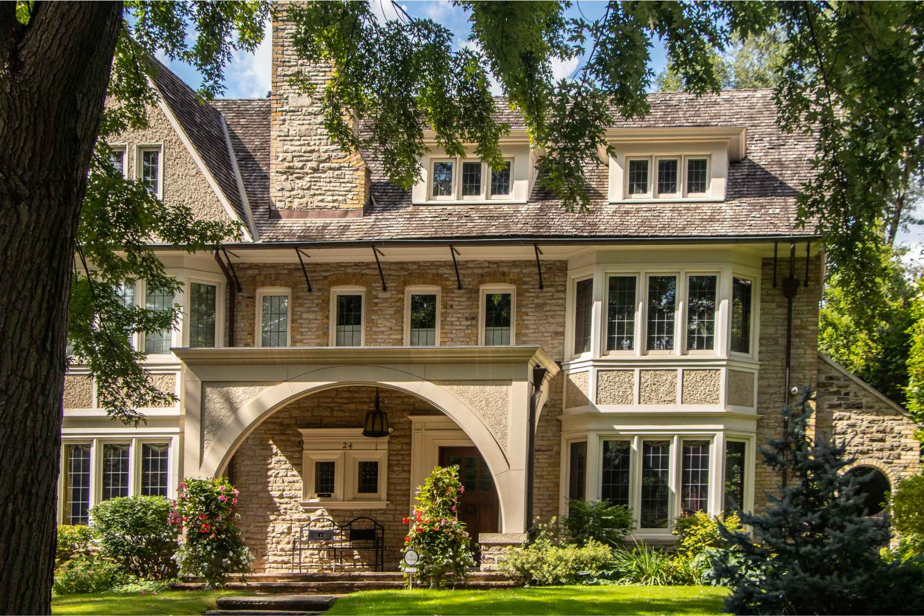 Brick Mansion in Rosedale with a Large Arch Over the Entrance Porch